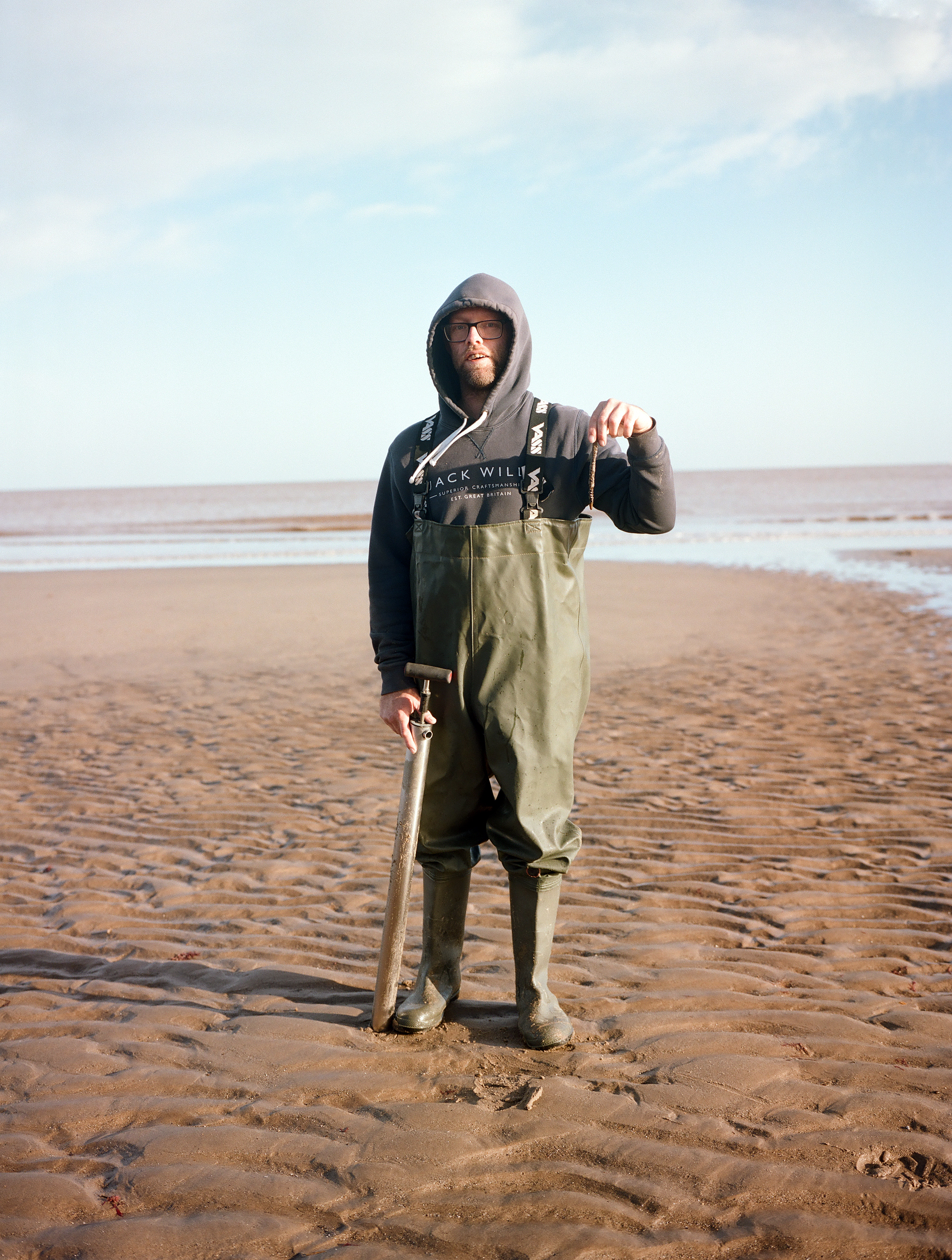 Man holding a fish on coast